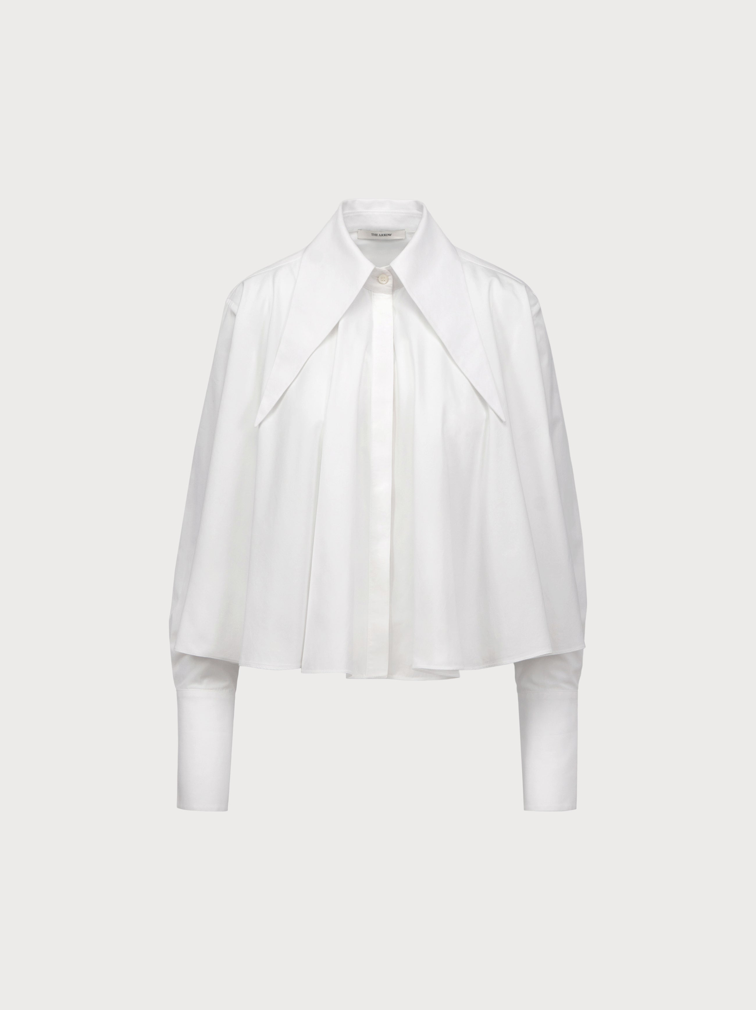 White blouse with a draped design on a light gray background