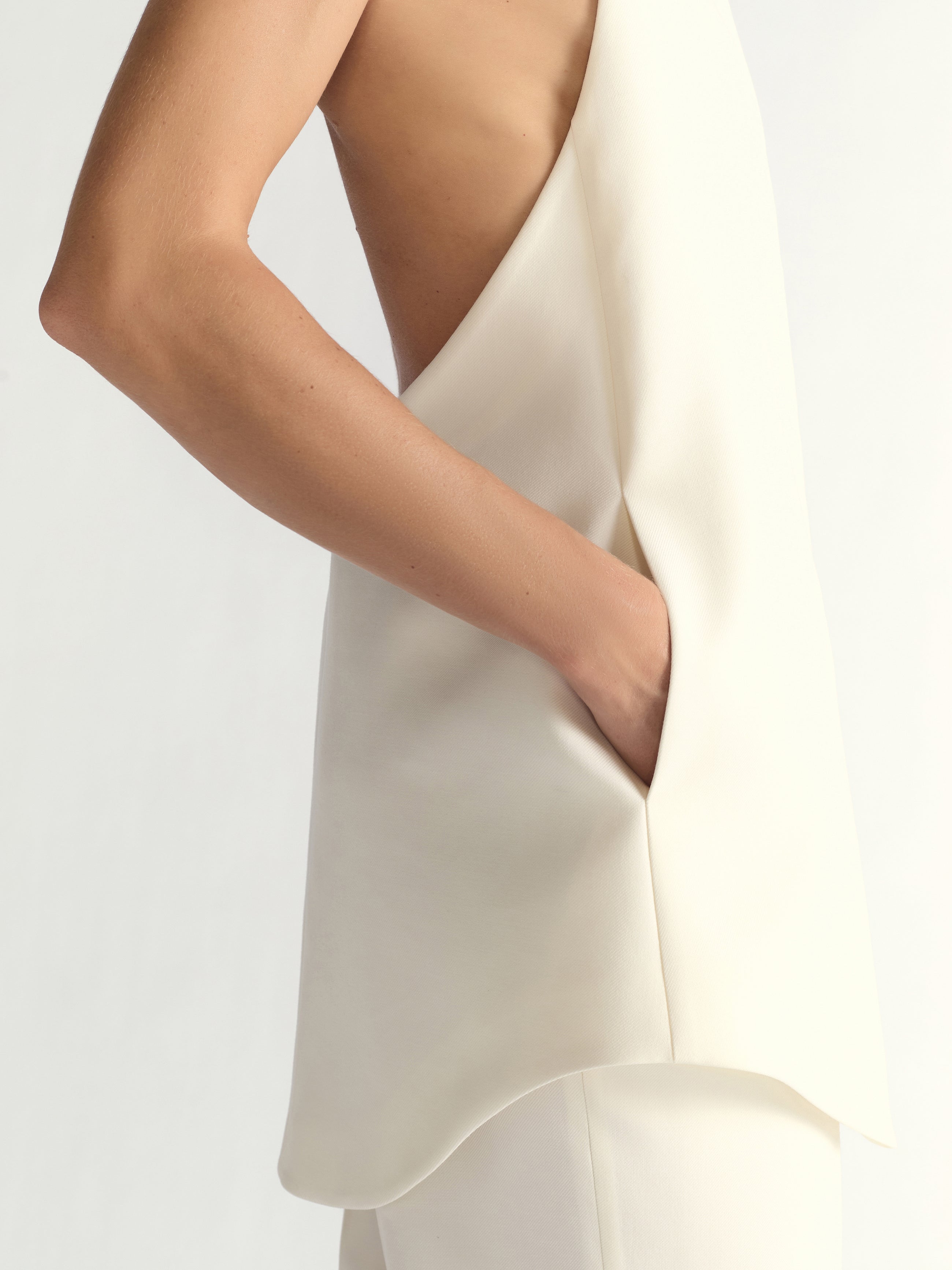 White dress with a plunging neckline on a plain background