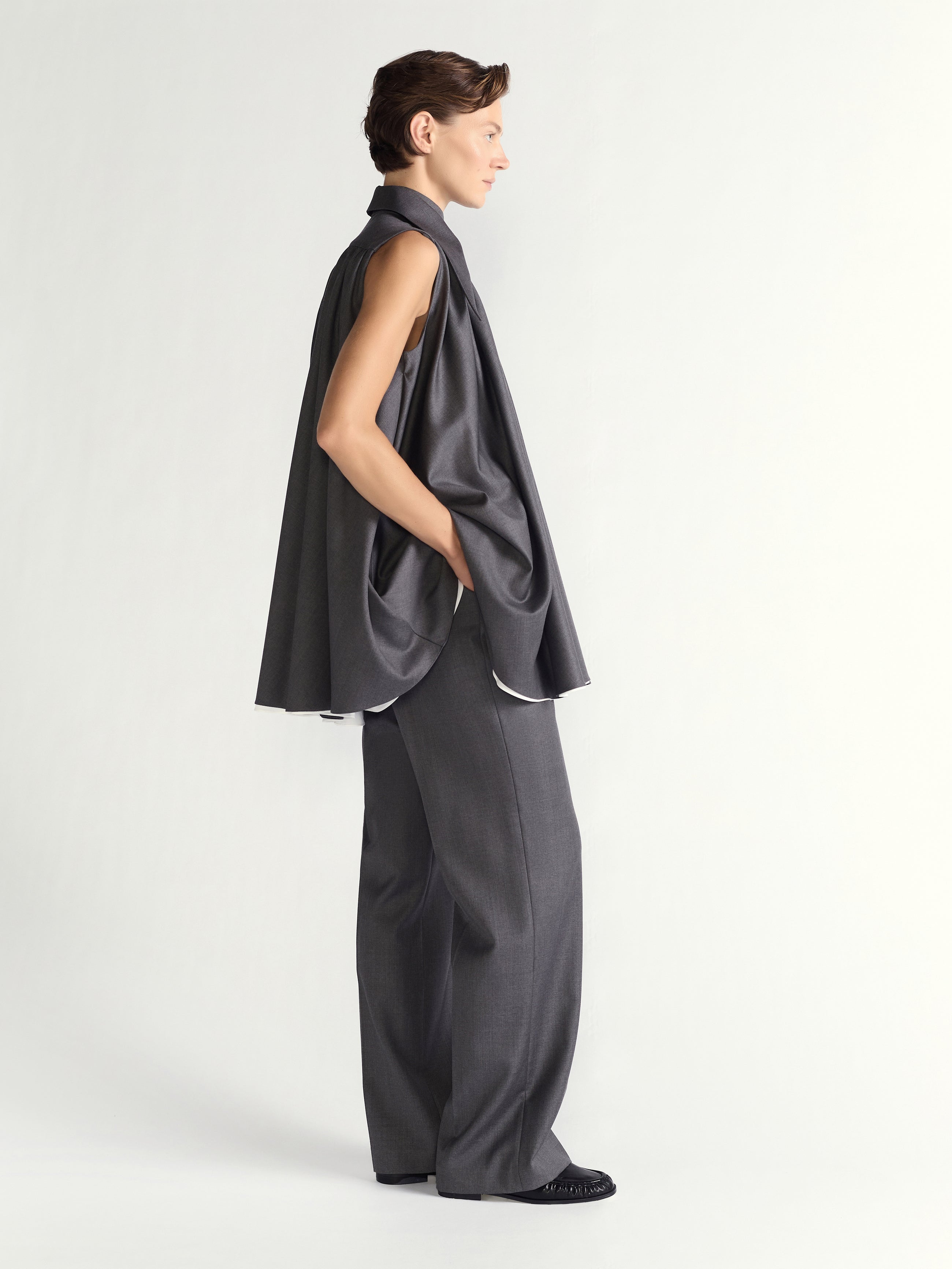 Woman wearing a gray dress on a white background