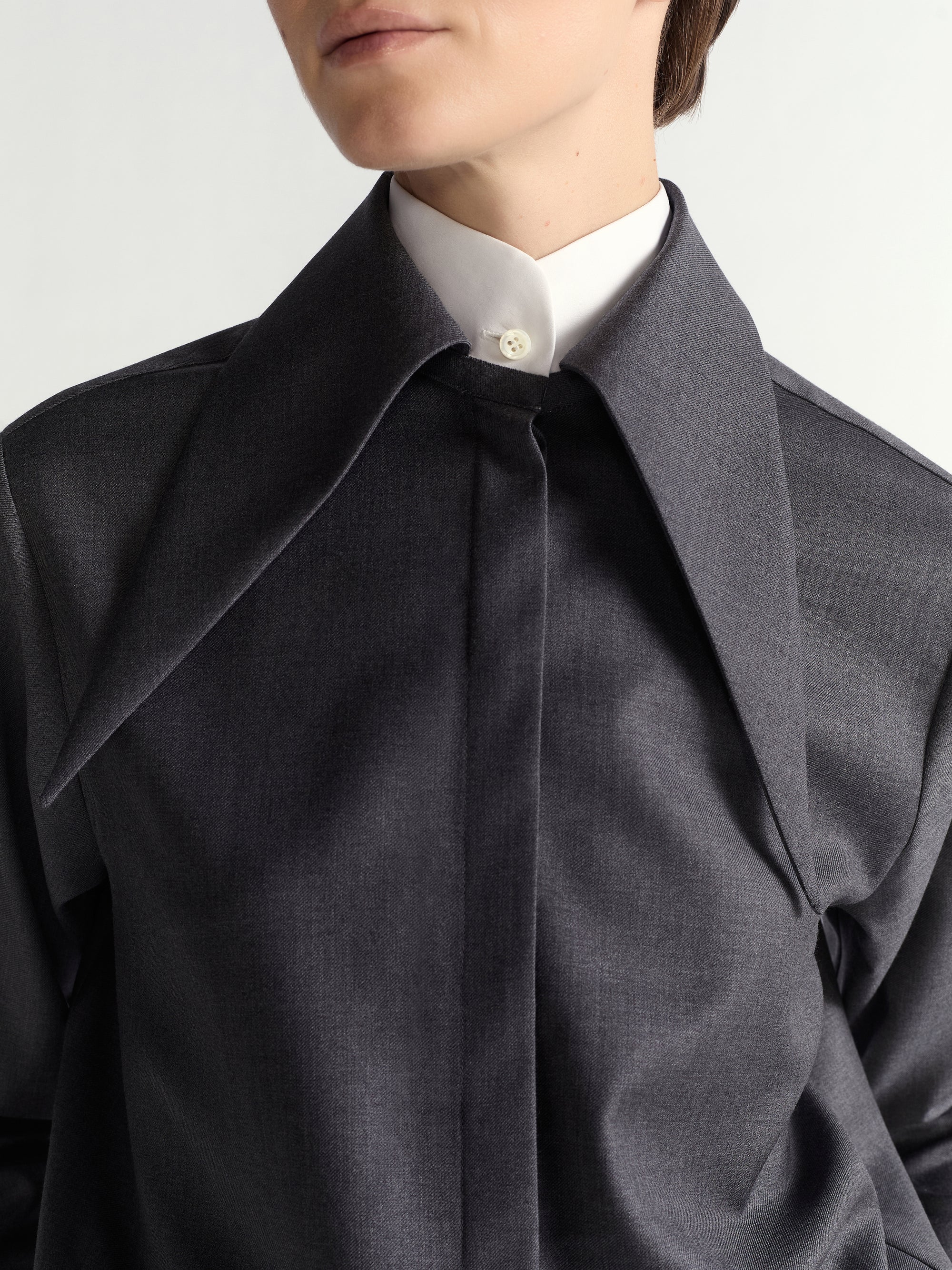 Close-up of a person wearing a dark gray shirt.