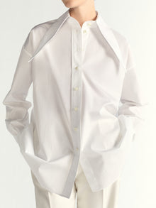 White button-up shirt worn by a person on a white background