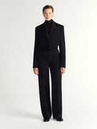 Person wearing black pants on a white background