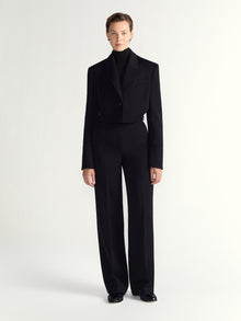 Person wearing black pants on a white background