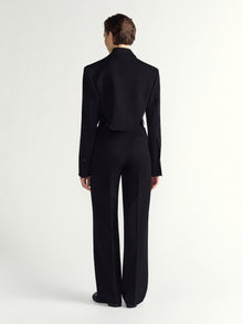 Person wearing black pants on a white background