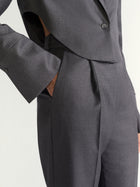 Gray suit jacket and pants on a white background