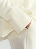 Close-up of an ivory blazer.