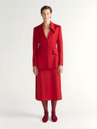 Woman wearing a red suit on a white background