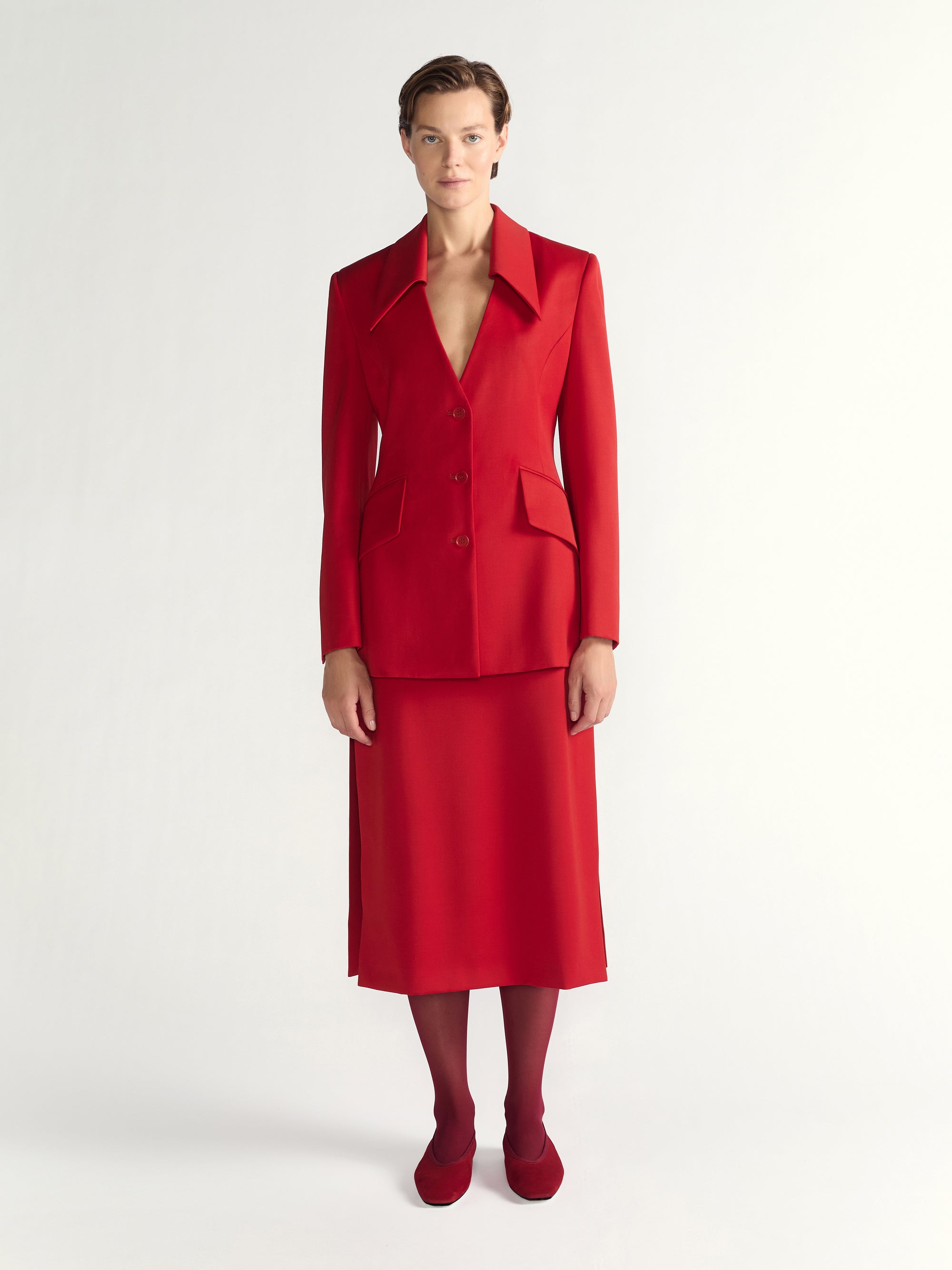 Woman wearing a red suit on a white background