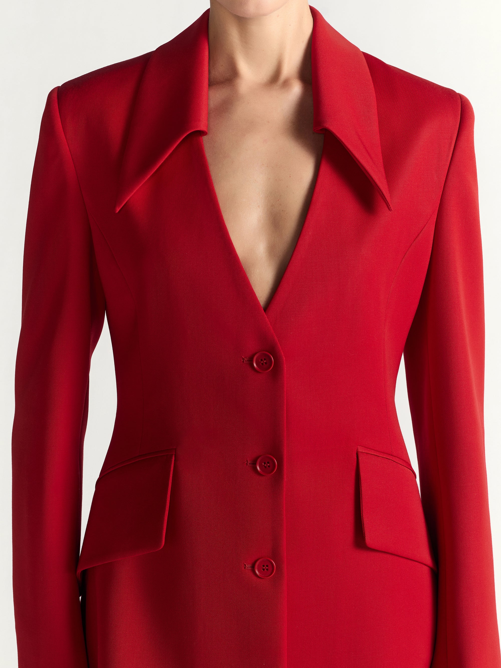 Red blazer with a plunging neckline on a white background