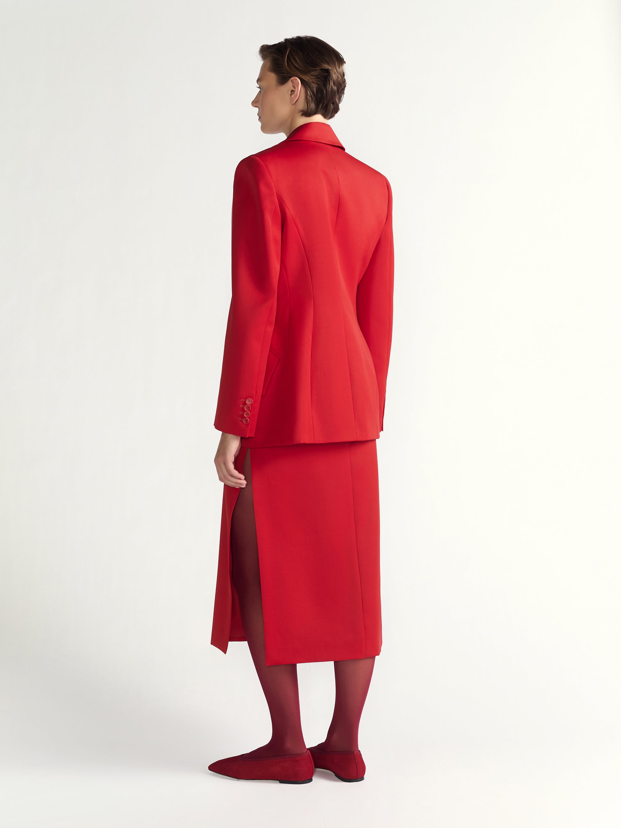 Person wearing a red suit on a white background