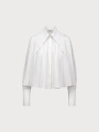 White blouse with a draped design on a light gray background