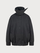 Dark gray jacket with a high collar on a light gray background