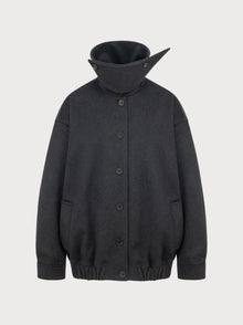 Dark gray jacket with a high collar on a light gray background