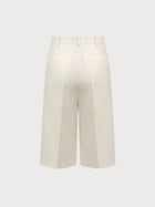 White wide-leg pants on a light gray background