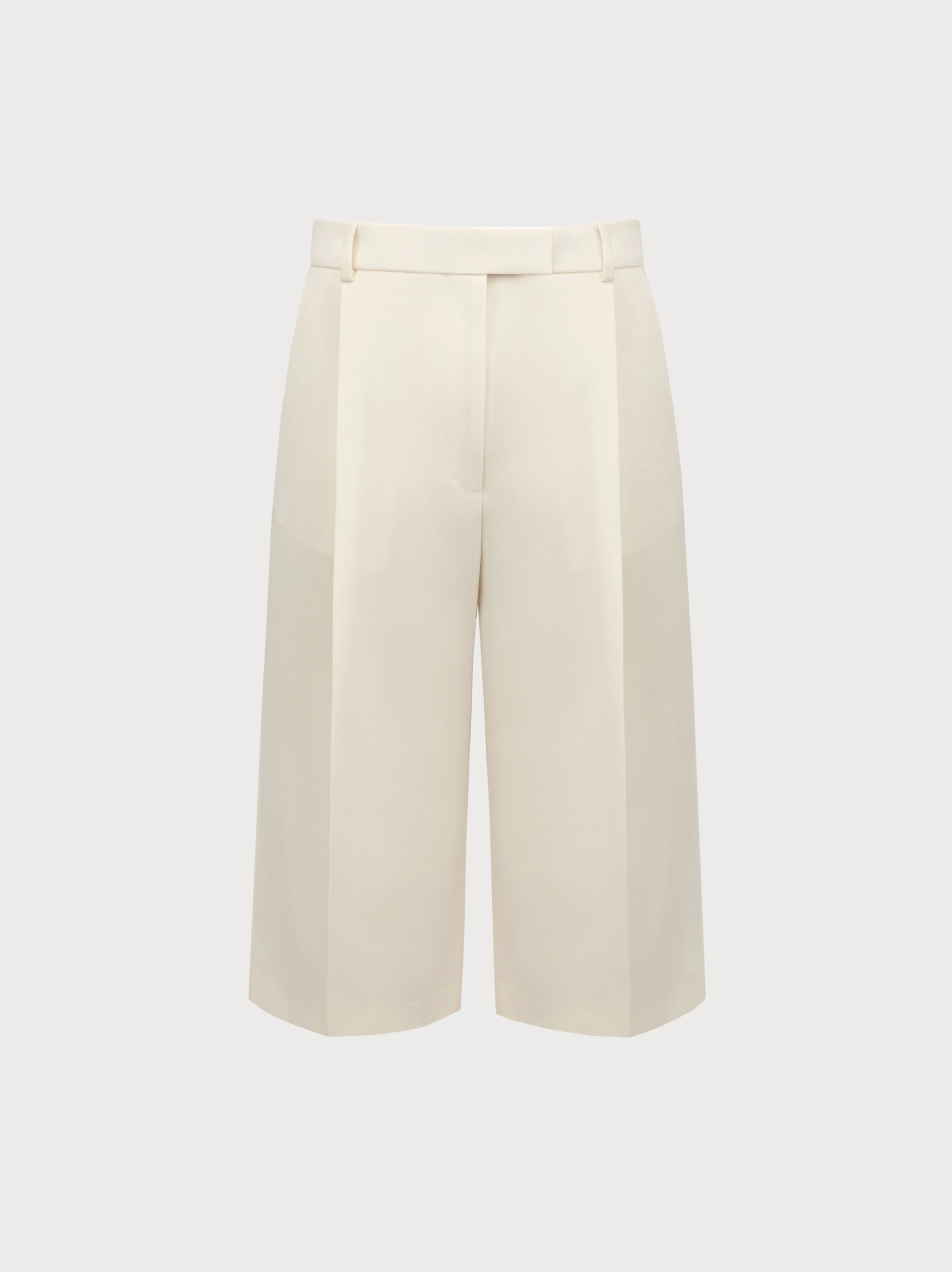 White wide-leg pants on a light beige background
