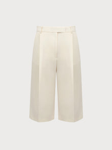 White wide-leg pants on a light beige background