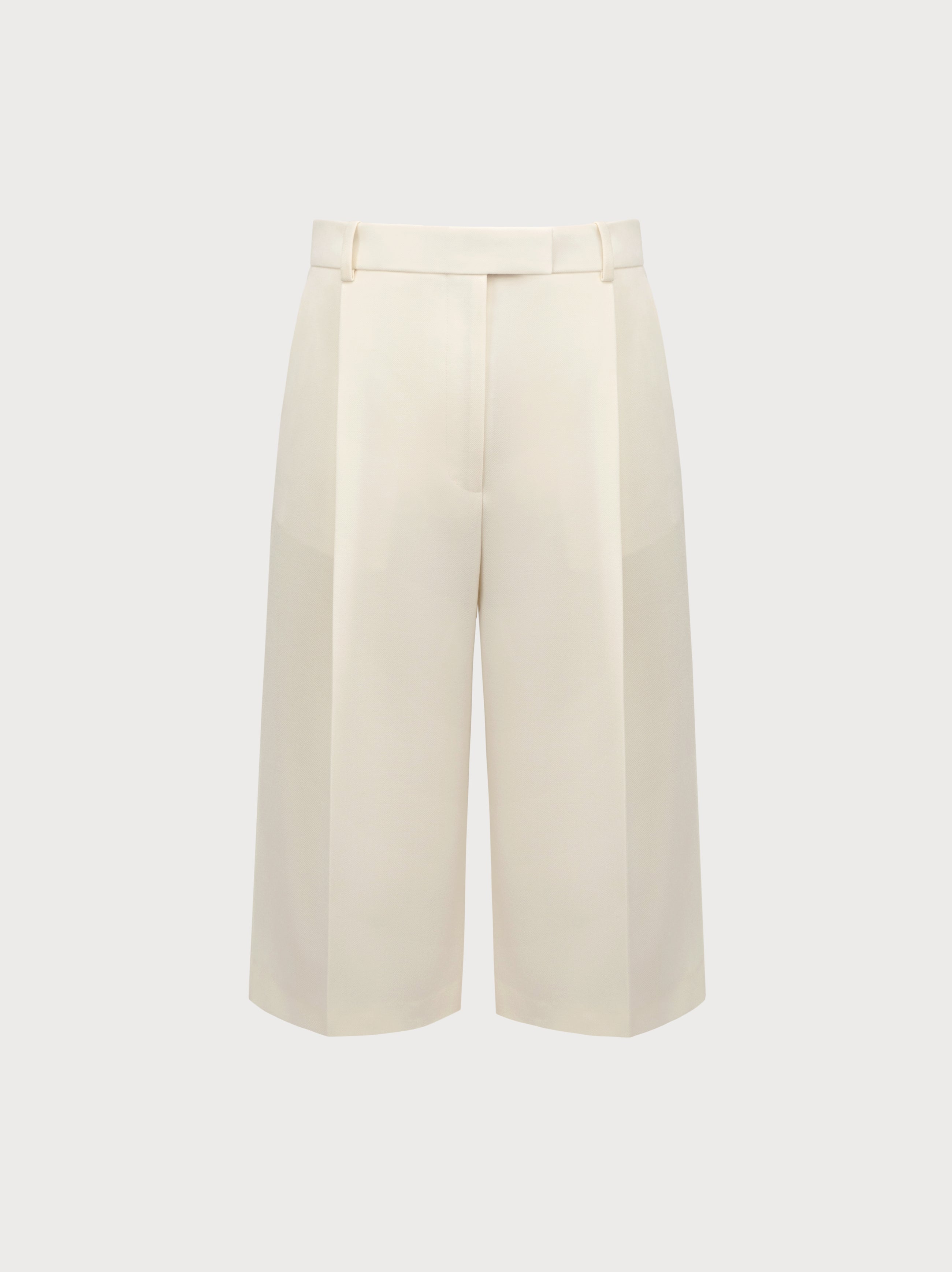 White wide-leg pants on a light beige background