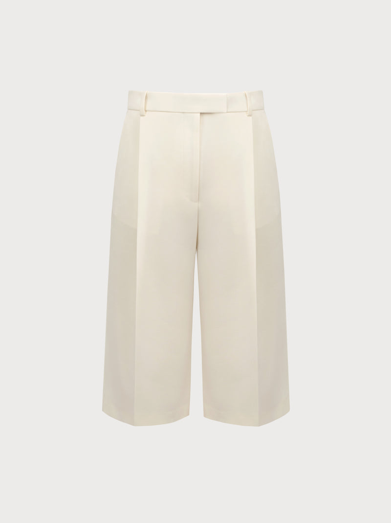White wide-leg pants on a light beige background